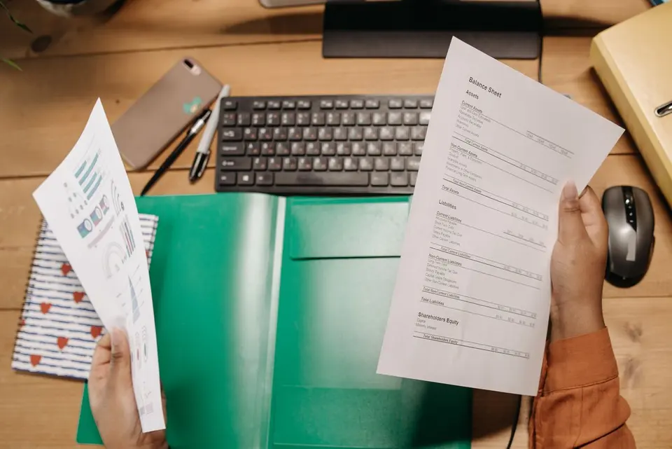 Person reviewing financial statements at a desk