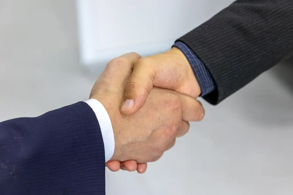 Two people shaking hands after an agreement